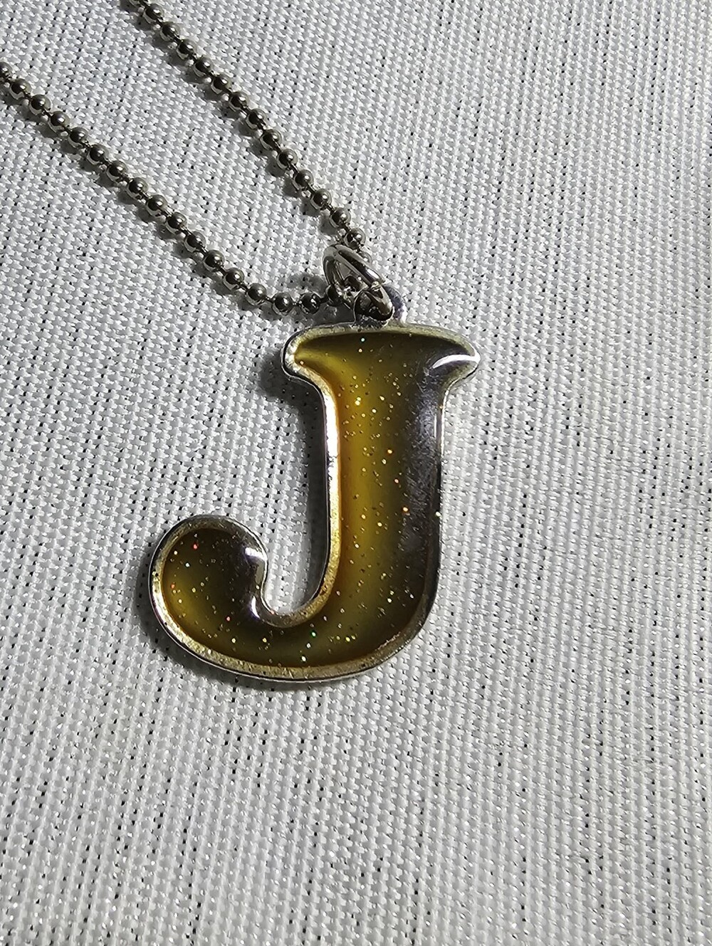 Letter J Pendant Necklace By Claires in Amber-Gold Resin Pendant